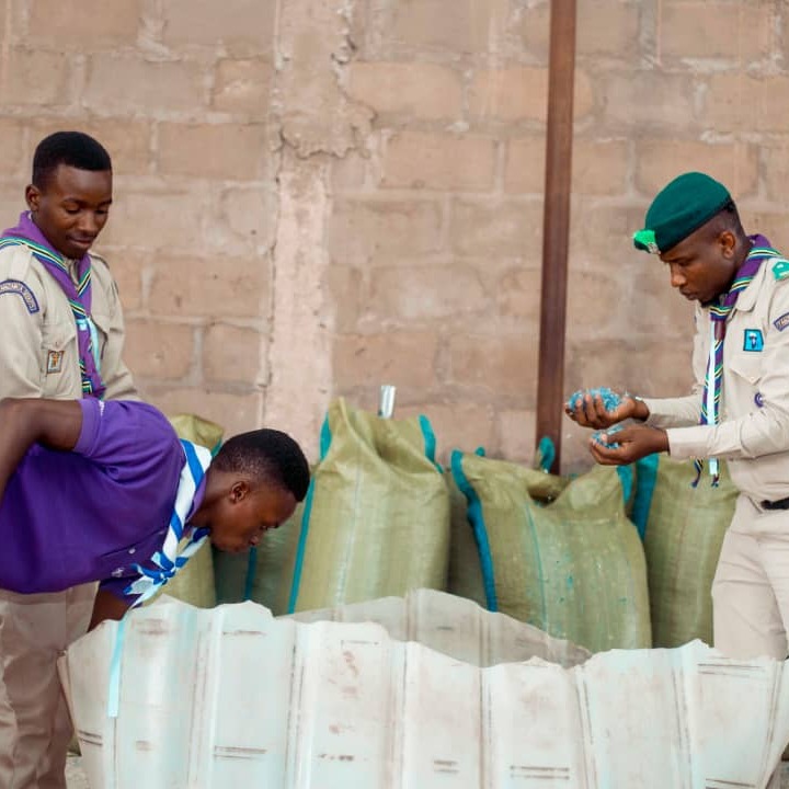 During a training visit to an environmental recycling plant, young Scouts observed small pieces of plastic that had been shredded by a machine, gaining hands-on experience and understanding of the recycling process and its importance in reducing plastic waste.